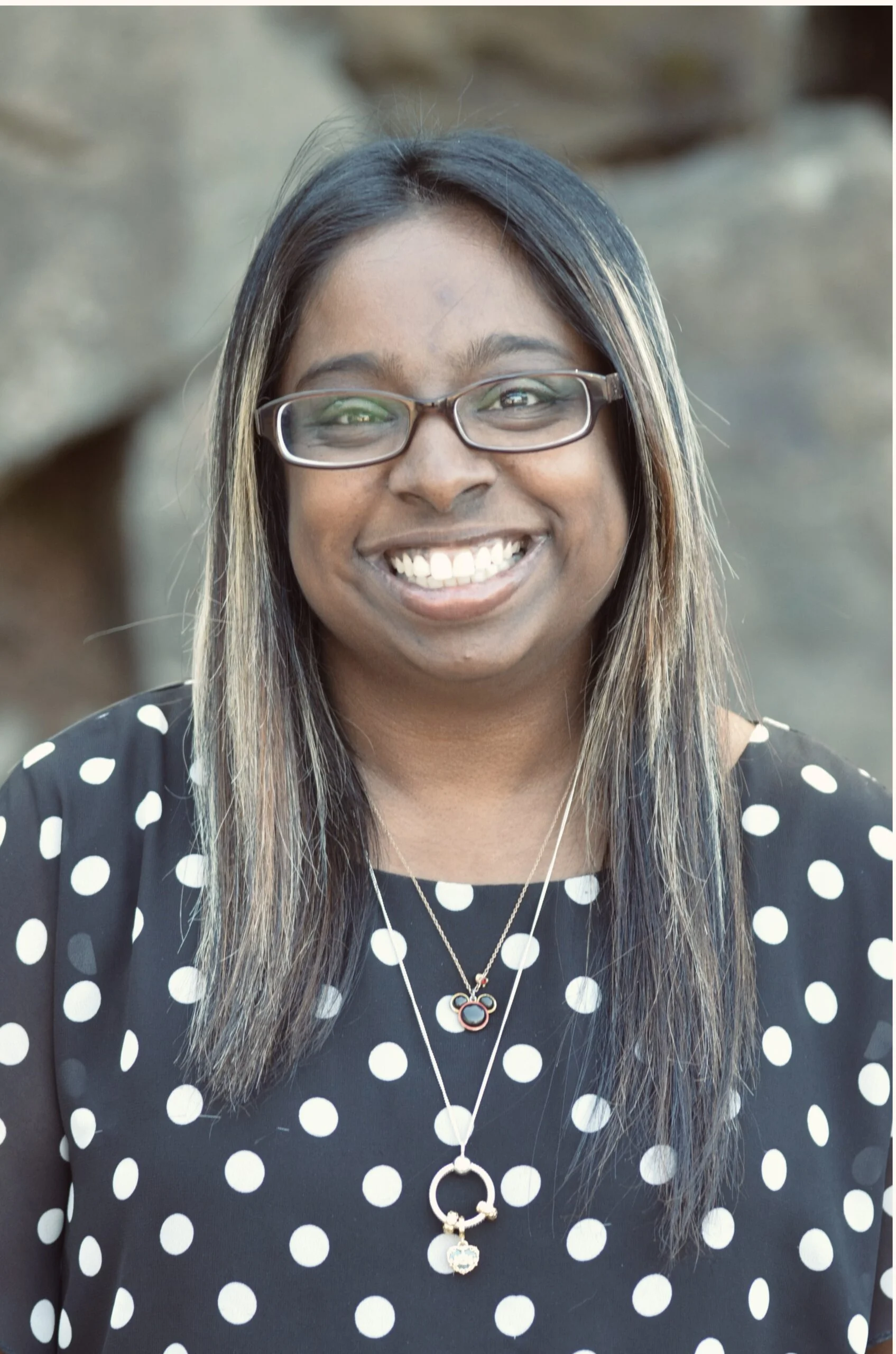 Female patient care coordinator in Burien, WA standing outside dental office